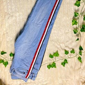 Blue jeans with black, white, and red stripes